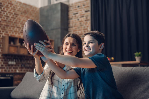 istock Mother and son playing with rugby ball 925339668