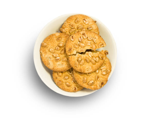 istock Cookies with nuts in white plate isolated on white background 925339702