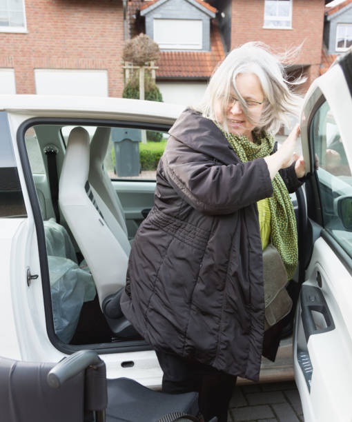 istock Disabled woman getting into a car 925340442
