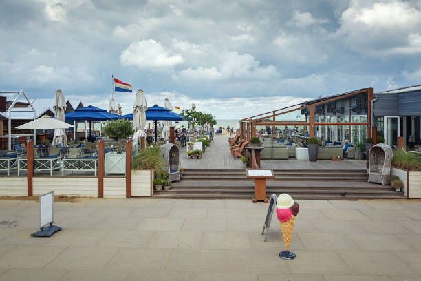 Blankenberge, West-Flanders, Belgium - February 21, 2023: tourists enjoy lunch in an inside  heated marquee of a seasonal restaurant on the dike on the beach