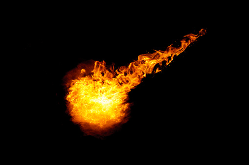 Meteorite fireball with fiery braid isolated on black background