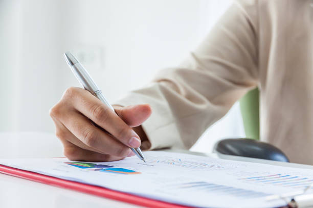 istock Hands of financial manager taking notes when working on report, Women working in office interior. 925349010
