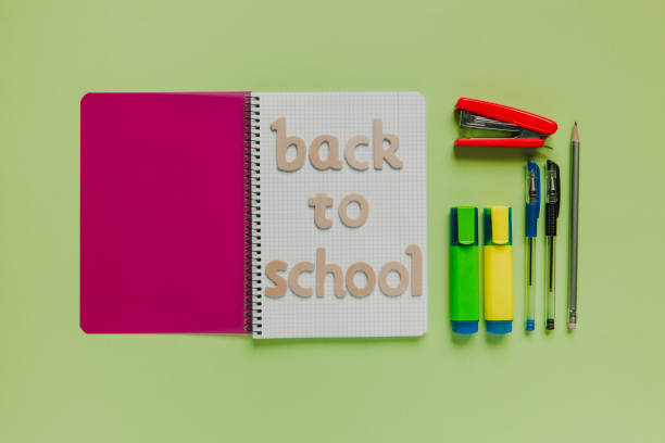 istock Back to school letters on a notebook with other stuff and green background. 925353478