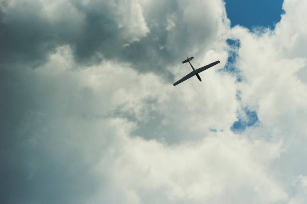 istock A Glider flying in blue sky with big white clouds. 925354452