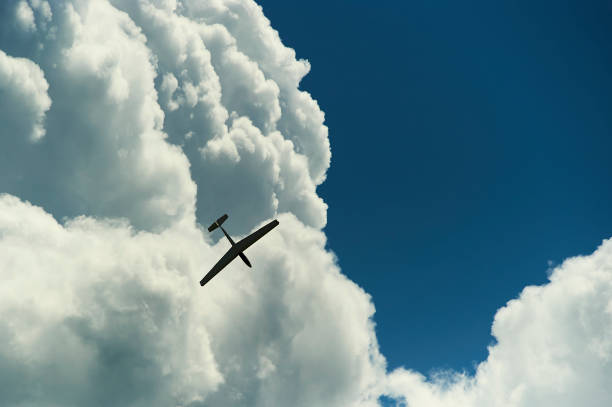 istock A Glider flying in blue sky with big white clouds. 925354462