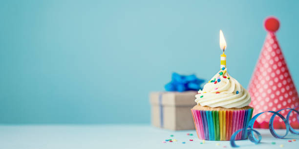 Birthday cupcake Birthday party background with cupcake, party hat and present birthday present stock pictures, royalty-free photos & images