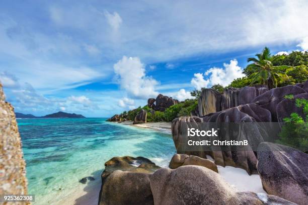 Rocks White Sand Palms Turquoise Water At Tropical Beach La Dique Seychelles Paradise 20 Stock Photo - Download Image Now