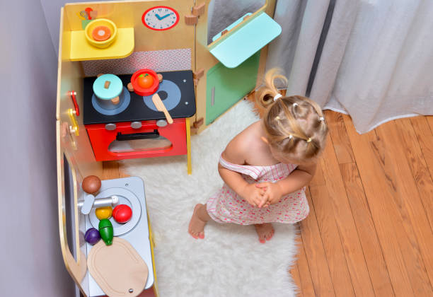 istock Girl playing with toy on a kitchen 925368838