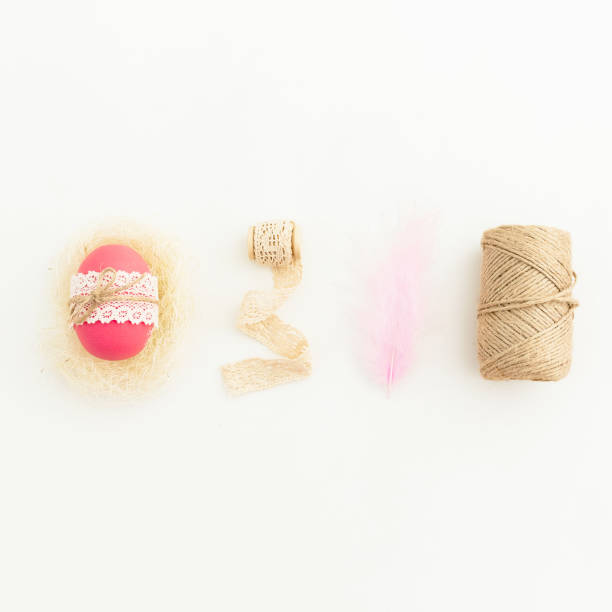 istock Easter composition with pink eggs with twine, feather and tapes on white background, Top view, Fat lay. Easter holiday 925368994