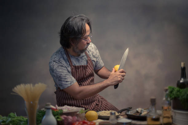 istock Man cook chef hipster with handsome bearded with a knife. 925370740