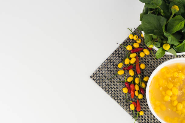 Typical amazonian cuisine spices selection: Jambu (regional herb), pepper sauce with tucupi (a liquid extracted from cassava root), and assorted colorful peppers. Exotic gastronomy concept
