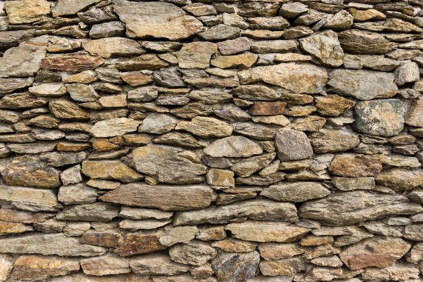 istock Dry masonry rock wall of natural stones 925381434