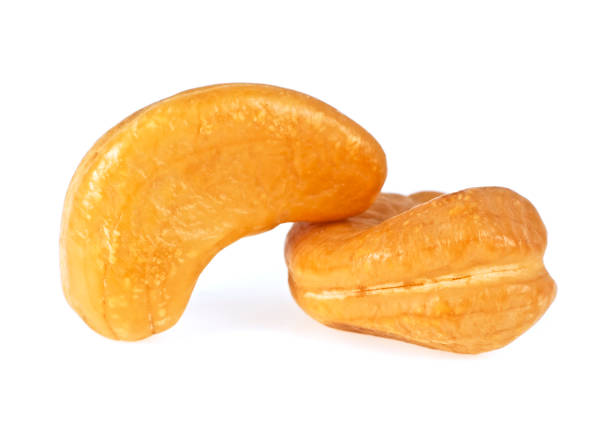 istock Two cashew nuts on a white background, closeup 925384920