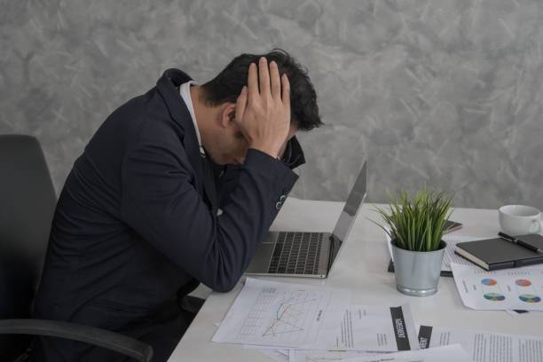 istock Tension, bad mood, stressed businessman touching his head with hands while using laptop in office. 925386060