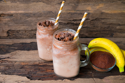 Banana and chocolate, smoothie milk, put glass on wooden floor