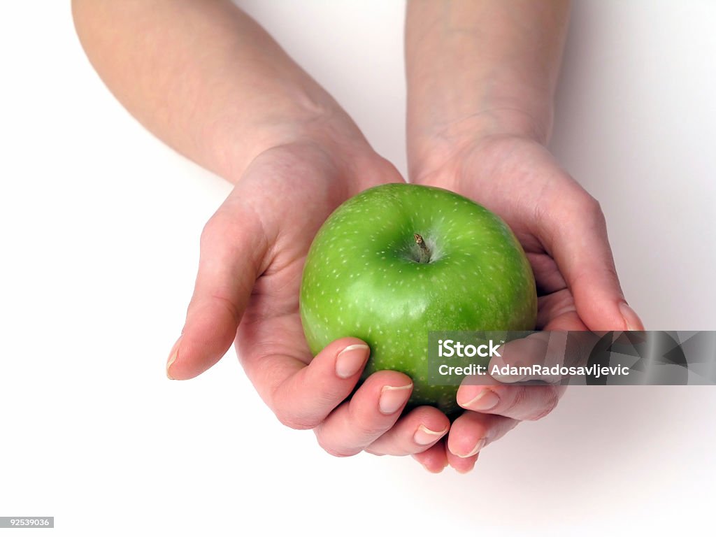 Apple in hand  Adult Stock Photo