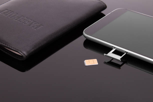 istock Smartphone and sim card on a dark background 925392874