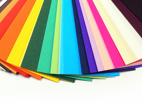 Colorful page markers stacked on a beige background.