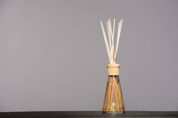 istock aroma liquid in a glass bottle with reed sticks isolated on grey background. 925396350