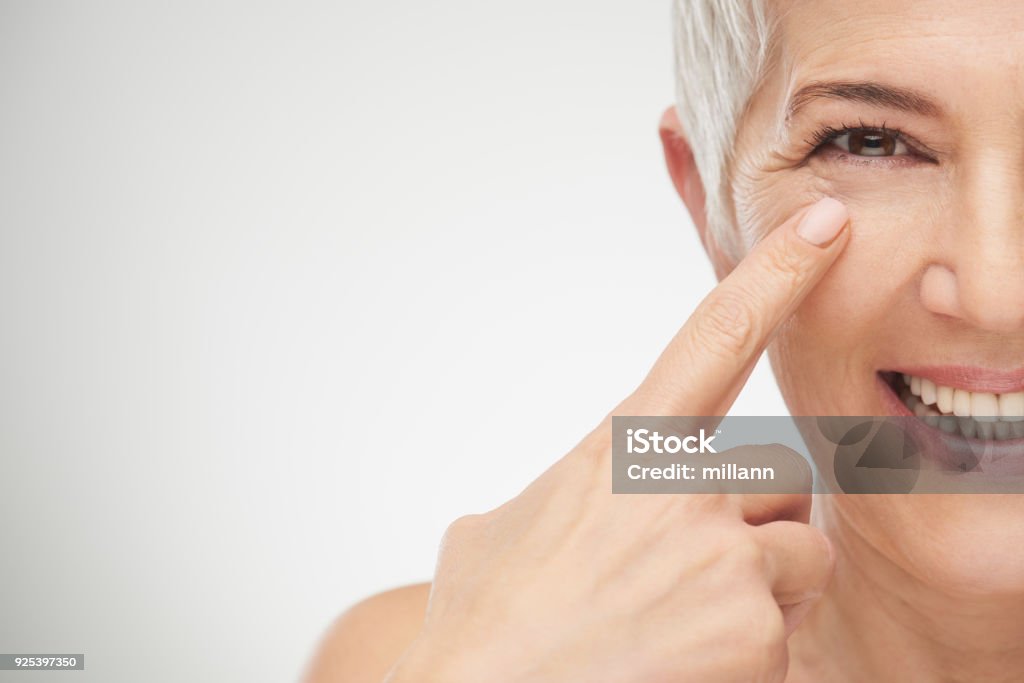 Close up of senior woman. Close up of senior woman showing wrinkles. Wrinkled Stock Photo