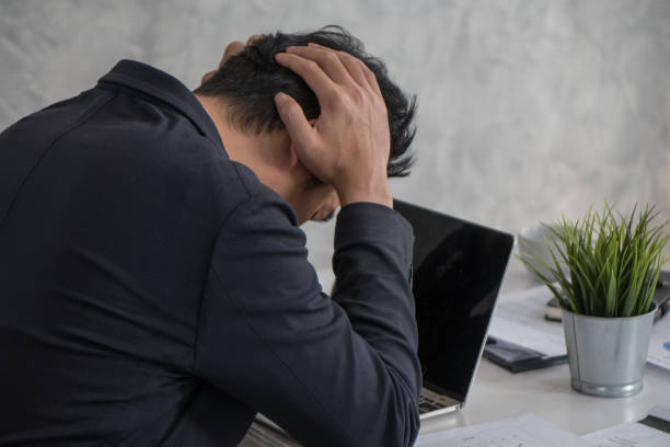 istock Tension, bad mood, stressed businessman touching his head with hands while using laptop in office. 925397722