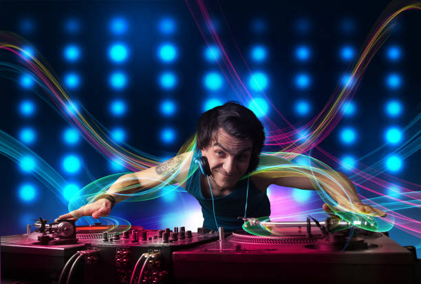 istock Young Dj mixing records with colorful lights 925397746