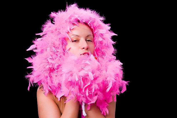 istock Young woman with pink feather boa 92540502