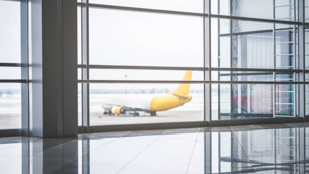 istock Panoramic windows in airport terminal with view on an aircraft 925407650