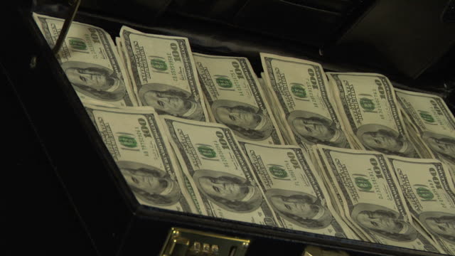 Stacks of 100 dollar bills in a briefcase