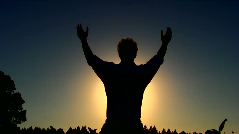 HD Young Man Praying Silhouetted