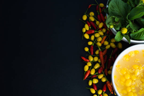 Typical amazonian cuisine spices selection: Jambu (regional herb), pepper sauce with tucupi (a liquid extracted from cassava root), and assorted colorful peppers. Exotic gastronomy concept