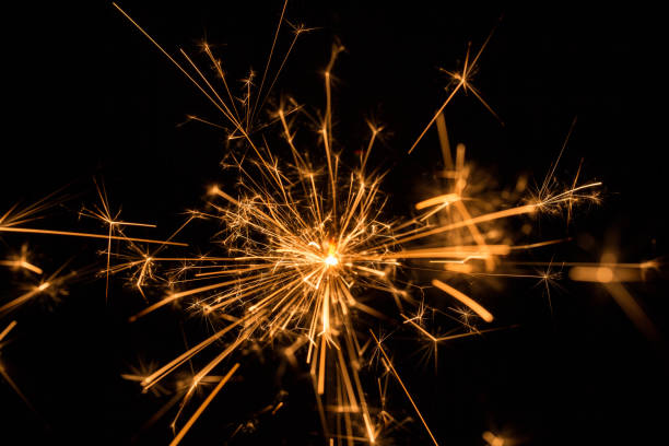 istock Burning sparkler with sparks bursting in air 925413344
