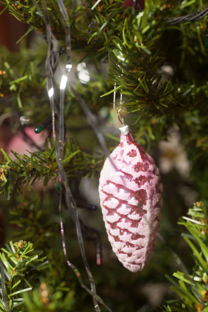 istock Glass cone hanging on green Christmas tree branch 925413436