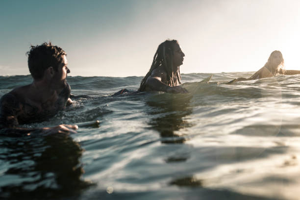 istock Friends enjoying into the sea and learning how to surfboarding 925416800