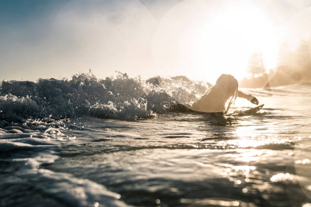 istock Young man enjoying into the sea and learn surfboarding 925416814