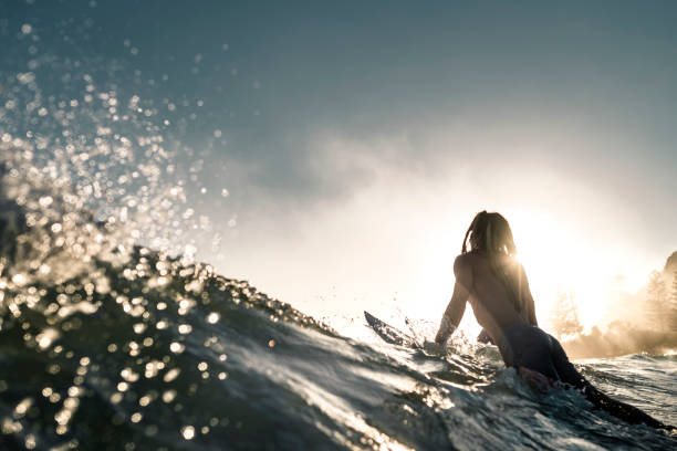 istock Young man enjoying into the sea and learn surfboarding 925416828