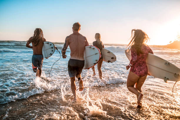 istock Friends running into the sea with surfboards 925416830