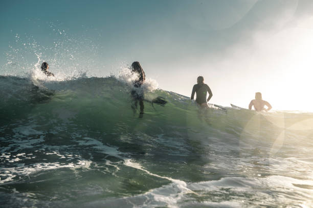 istock Friends enjoying into the sea and learning how to surfboarding 925416844