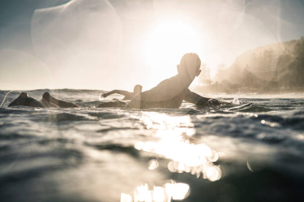 istock Friends enjoying into the sea and learning how to surfboarding 925416870