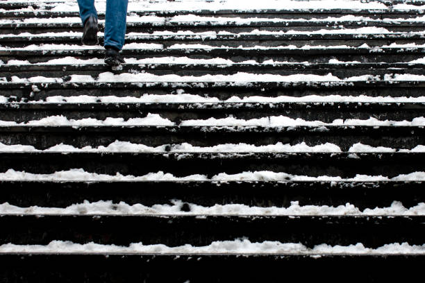 Legs up the stairs in winter snow Legs of a person walking up the snowy stairs in motion blur slippery unrecognizable person safety outdoors stock pictures, royalty-free photos & images