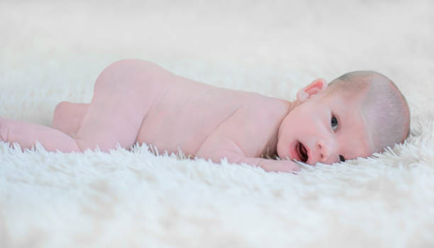 istock Newborn baby boy lying on his stomach on a soft blanket 925421302
