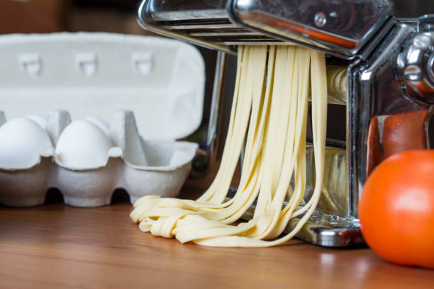 istock machine for rolling dough and cutting Italian pasta, eggs and flour 925421584