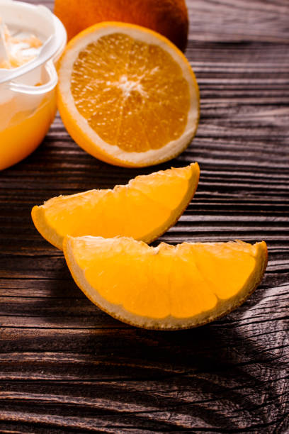 istock oranges and juice on a wooden background 925424466