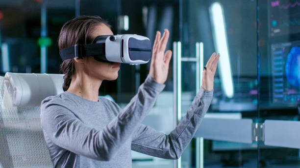 istock In Laboratory Scientist Wearing Virtual Reality Headset Sitting in a Chair Interacts With Monitors Showing Brain Activity, and Neurological Data. Modern Brain Study/ Neurological Research Center. 925425894