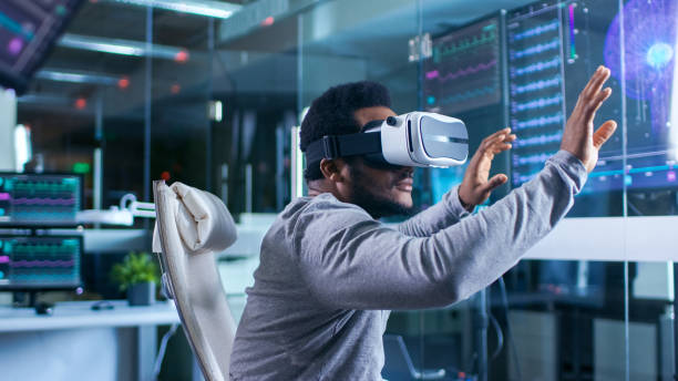 istock In Laboratory Scientist Wearing Virtual Reality Headset Sitting in a Chair Interacts With Monitors Showing Brain Activity Information. Modern Brain Study/ Neurological Research Center. 925426028