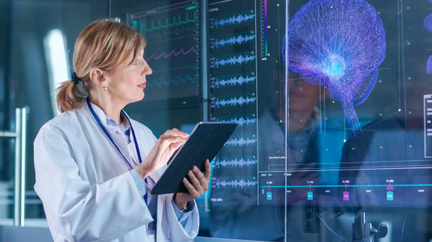 istock Female Scientist Uses Tablet Computer In the Modern Brain Study Laboratory and Monitors EEG Reading and Brain Model Functioning. 925426274
