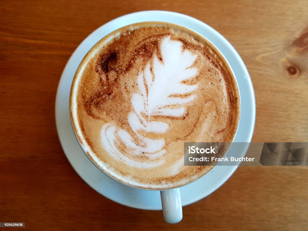 drinking a hot cup of coffee with milk / latte and foam / mug at breakfast Cappuccino Stock Photo