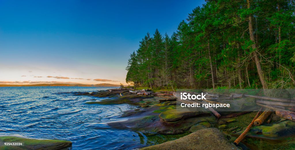 Scenic panoramic view of the ocean and Jack Point and Biggs Park in Nanaimo, British Columbia. Scenic sunset panoramic view of the ocean overlooking at the Strait of Georgia from Jack Point and Biggs Park in Nanaimo, British Columbia. Nanaimo Stock Photo