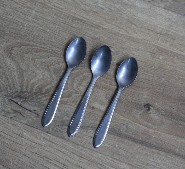 istock Set of silver tea spoons on wooden background 925432556