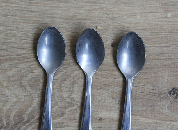 istock Set of silver tea spoons on wooden background 925432574
